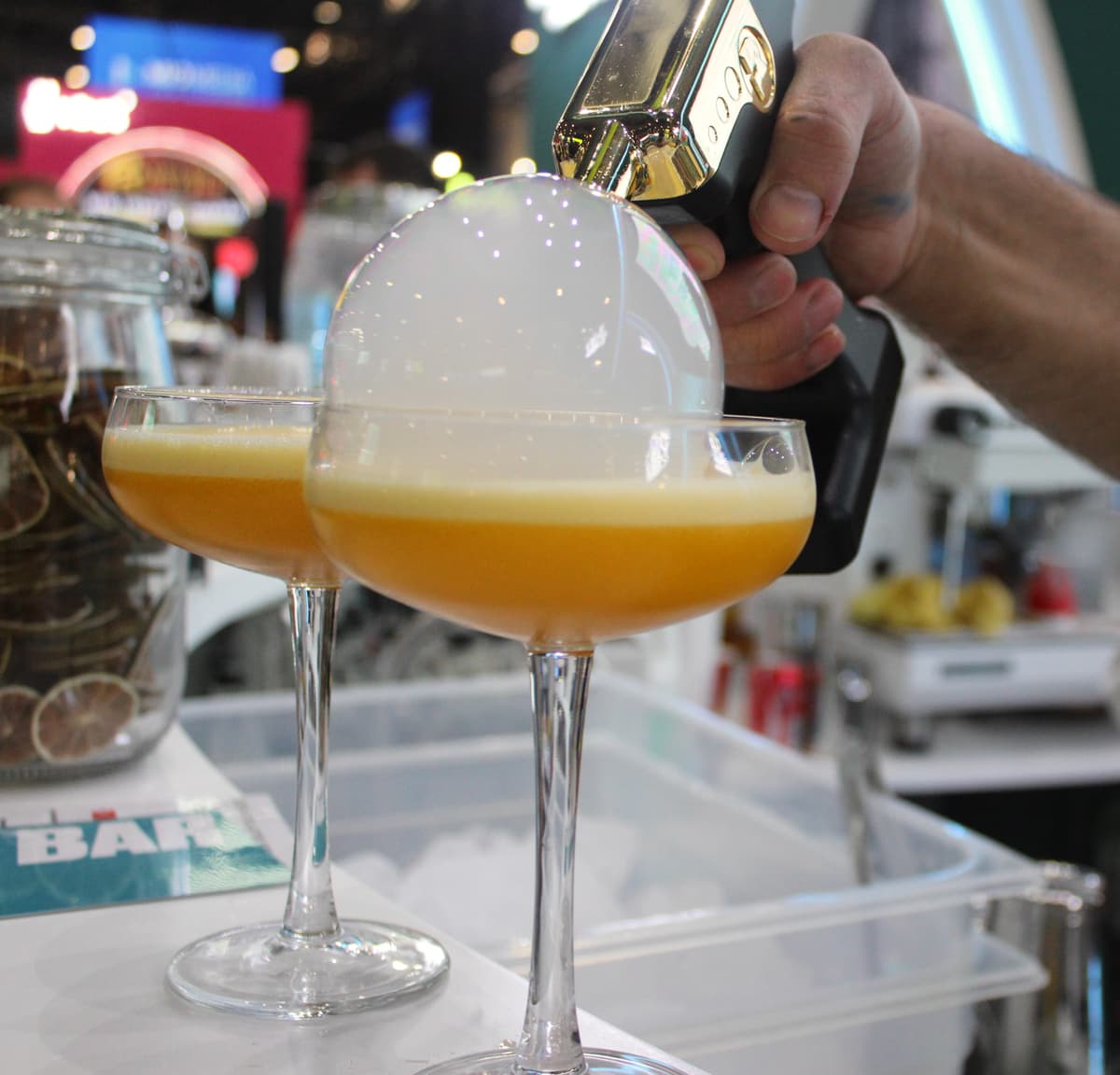 Two bartenders preparing drinks at customer's wedding cocktail bar